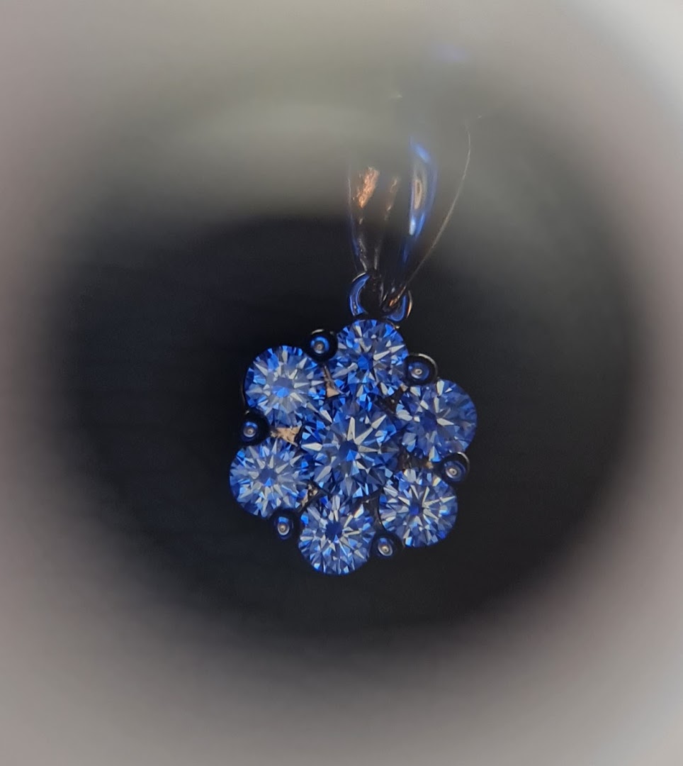 A close-up of a stunning blue gemstone cluster pendant from Lee Hwa Jewellery.