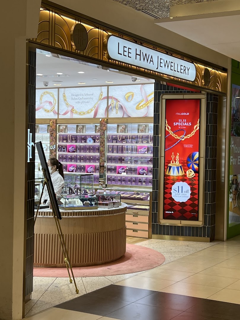 The image shows the elegant entrance and interior display of Lee Hwa Jewellery, featuring sparkling items.