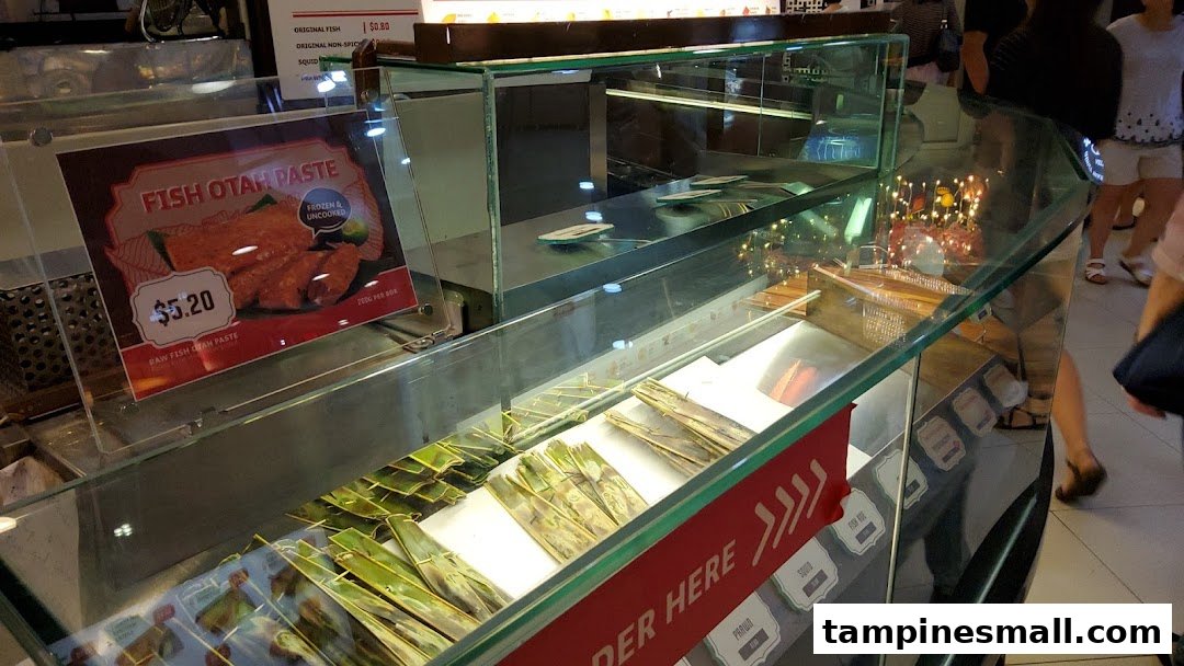 A display counter at Lee Wee Brothers showcasing various otah products and pricing.