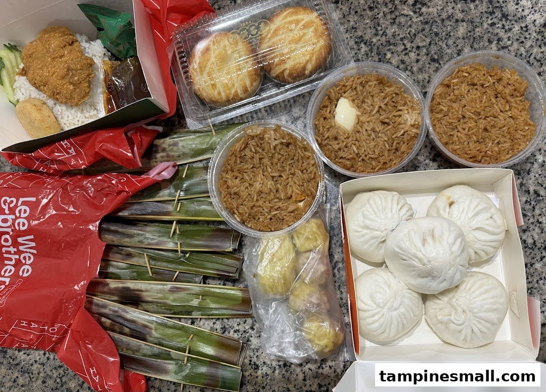 A delicious spread of takeaway dishes from Lee Wee Brothers, including nasi lemak, otah, fried rice, and pastries.