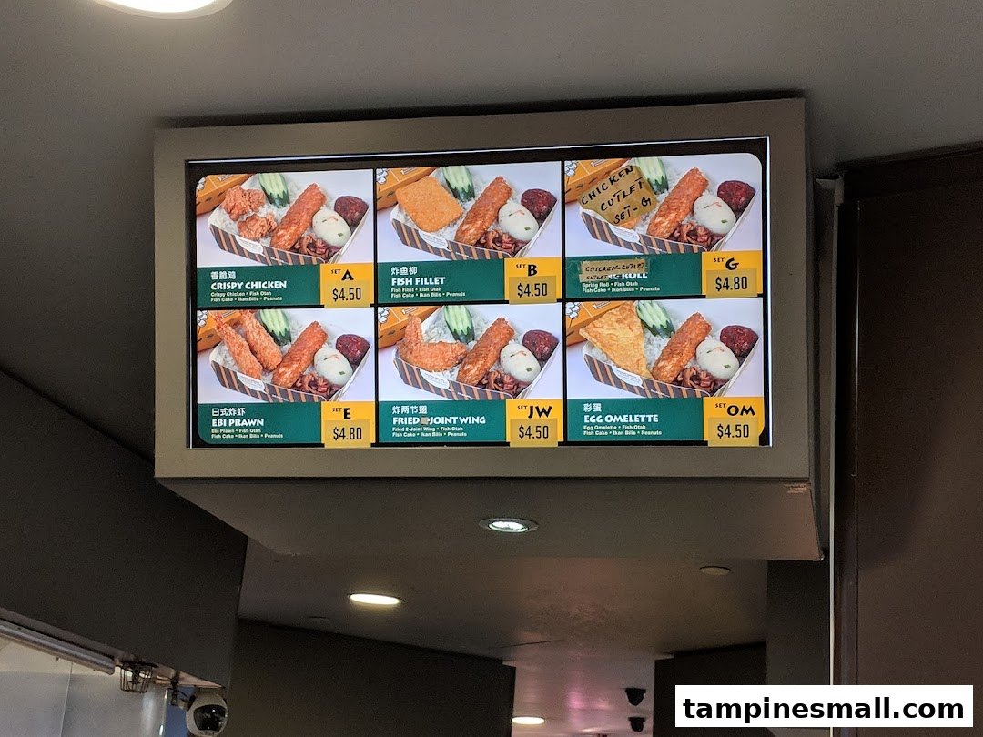A digital menu board displaying various set meals with images, names, and prices.