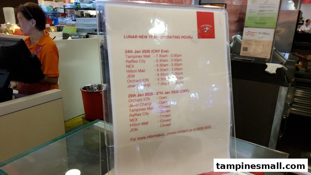 A sign displaying Lee Wee Brothers' Lunar New Year operating hours for various mall outlets in 2020.
