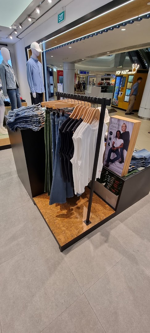 Interior view of Levi's store, showcasing denim jeans, apparel displays, and mannequins.