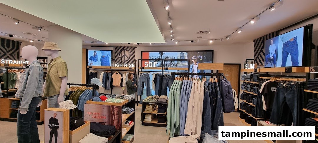 Interior view of a Levi's store showcasing denim, apparel displays, mannequins, and digital screens.