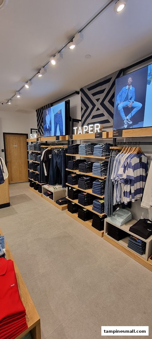 Interior view of a Levi's store showcasing various denim jeans and apparel on display.