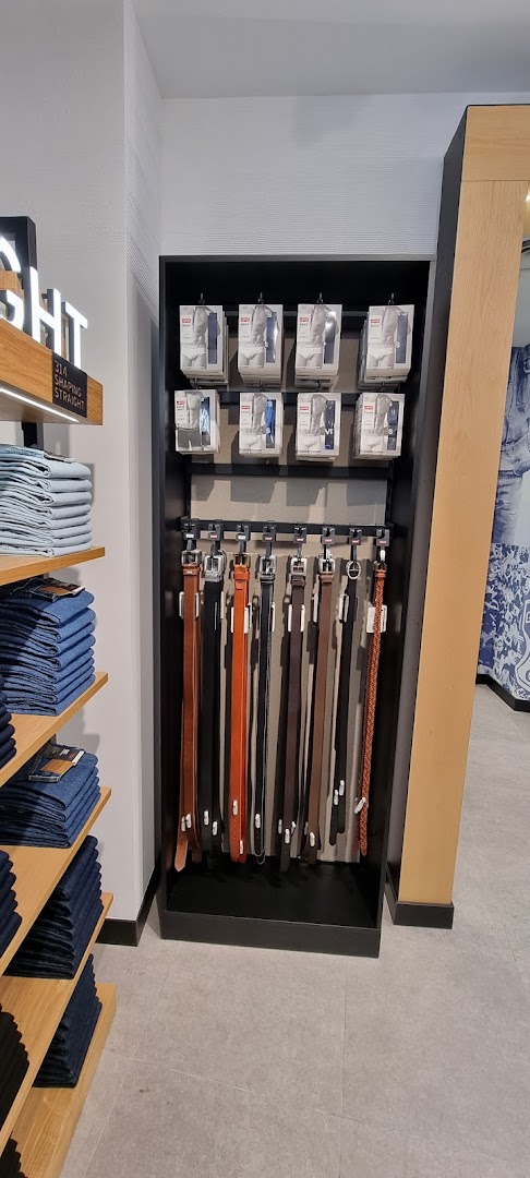 Interior view of Levi's store displaying belts, folded jeans, and packaged items.