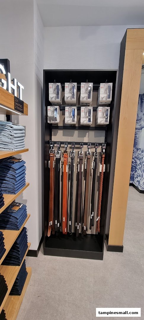 Interior view of Levi's store displaying belts, folded jeans, and packaged items.