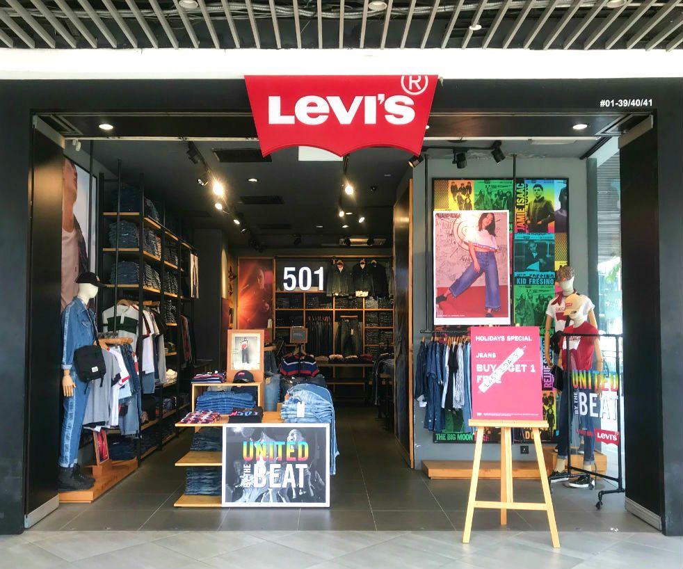 The Levi's store entrance showcasing denim apparel, mannequins, and promotional displays.