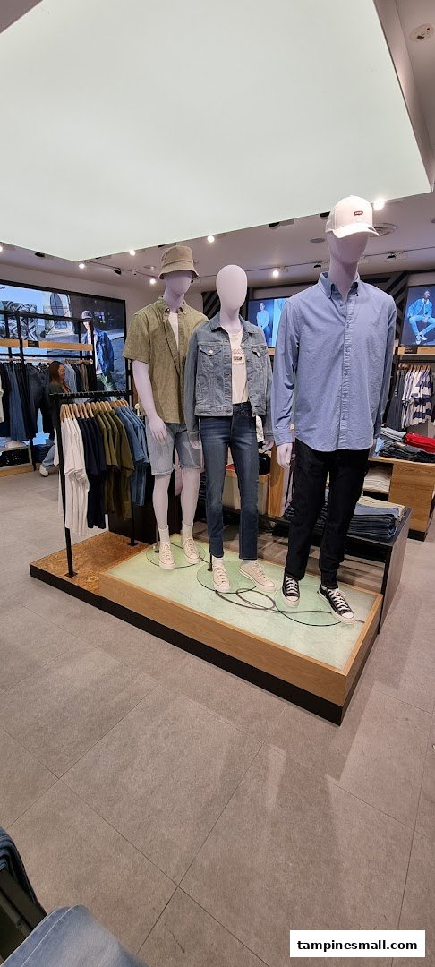 Mannequins display casual denim and apparel inside the Levi's store, showcasing current styles.