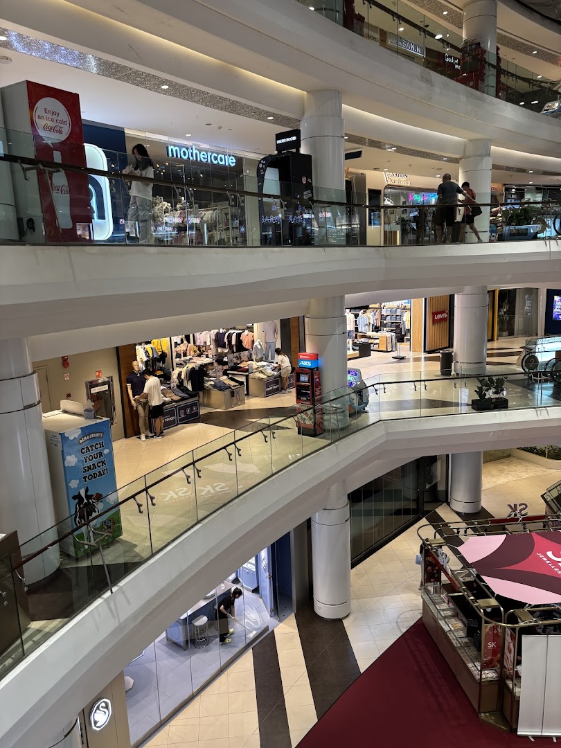 A multi-level interior view of Tampines Mall, showcasing various retail shops and walkways.