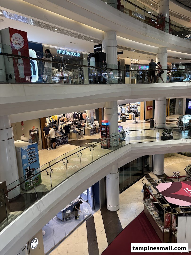 A multi-level interior view of Tampines Mall, showcasing various retail shops and walkways.