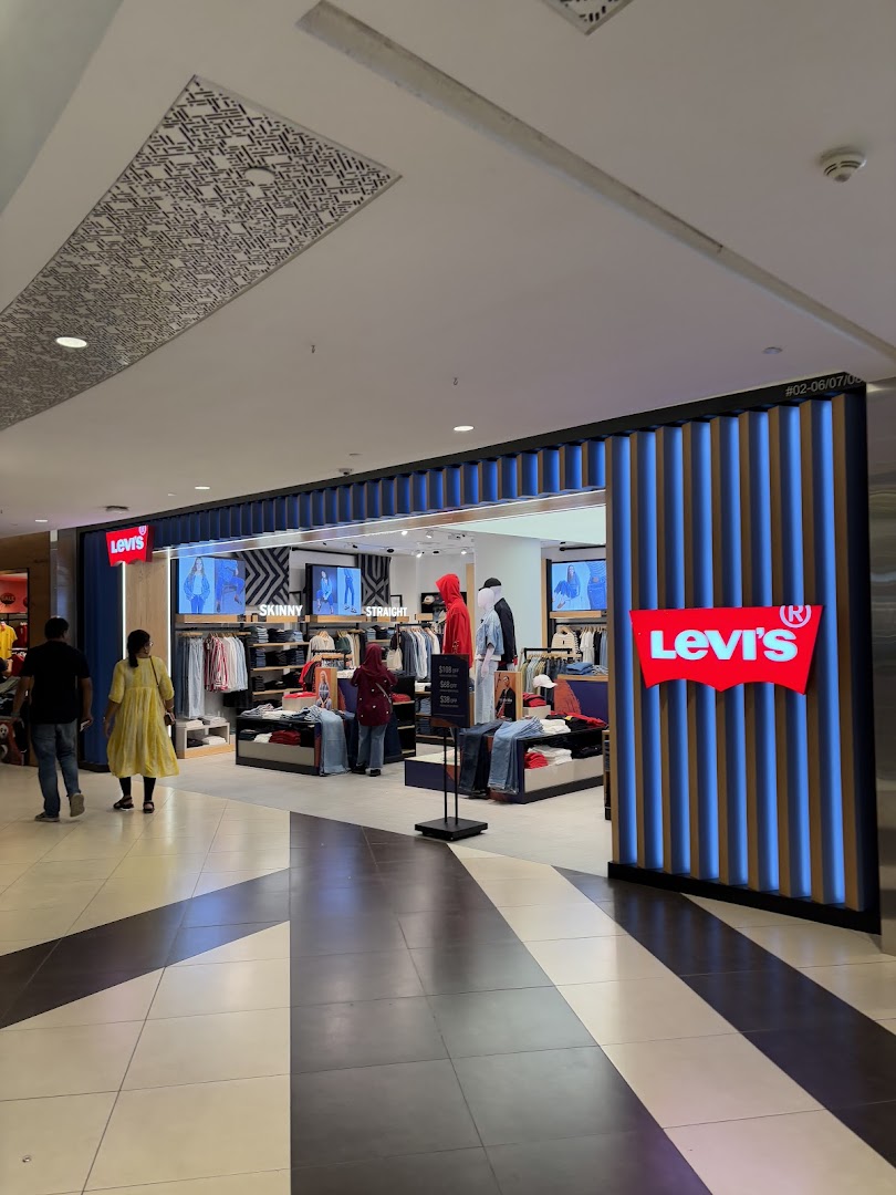 The image captures the vibrant entrance of a Levi's store, showcasing its denim collection and inviting interior.