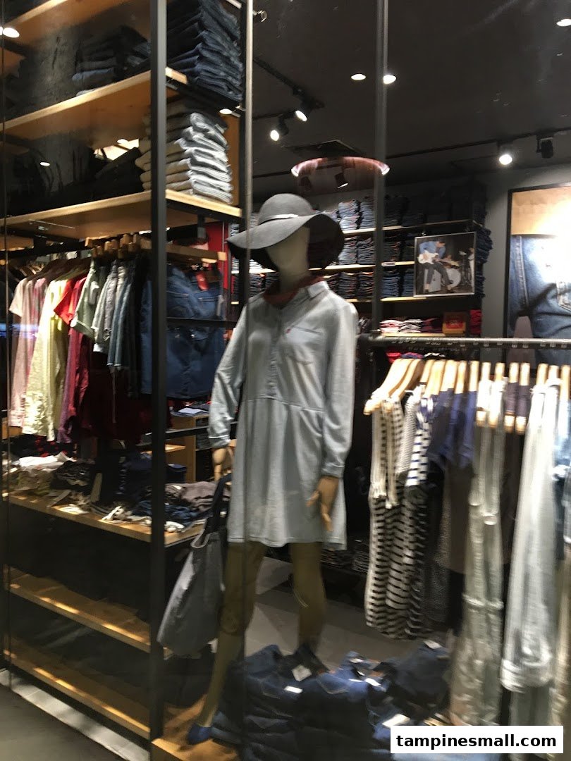 Interior view of a Levi's store, showcasing clothing racks, folded denim, and a mannequin.