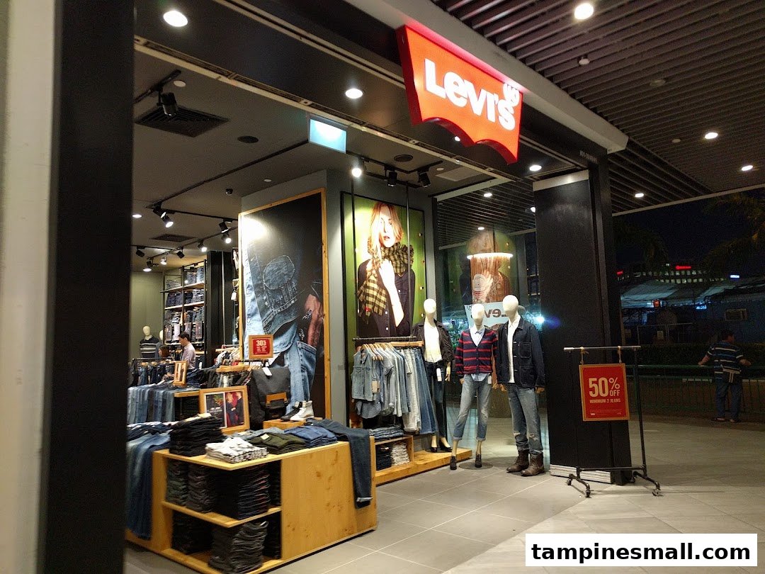 Exterior view of the Levi's store entrance, showcasing denim apparel and mannequins.