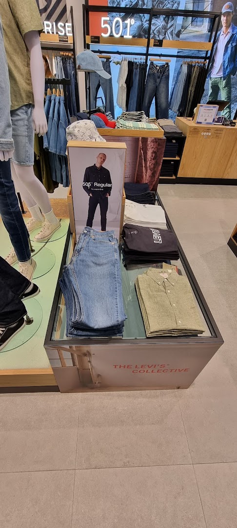 Interior view of Levi's store showcasing denim, apparel displays, and promotional signage.