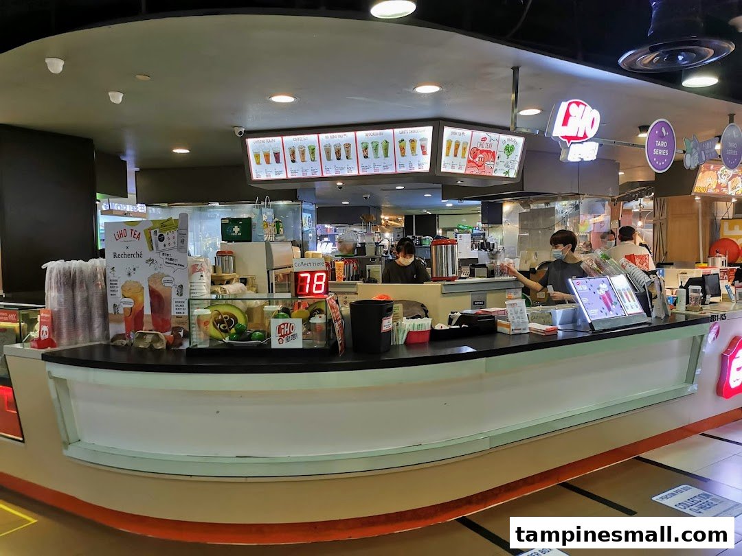LiHO TEA counter with staff preparing drinks and various promotional displays.