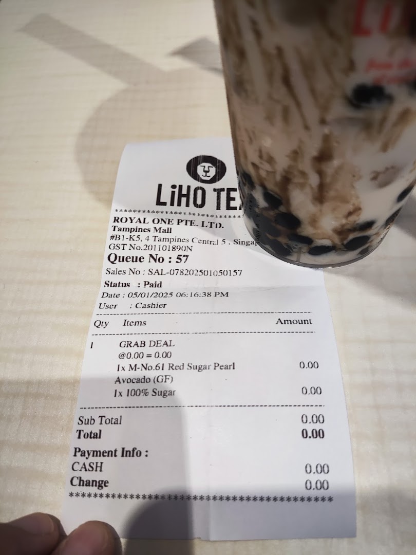 A LiHO TEA receipt and a bubble tea drink on a table.