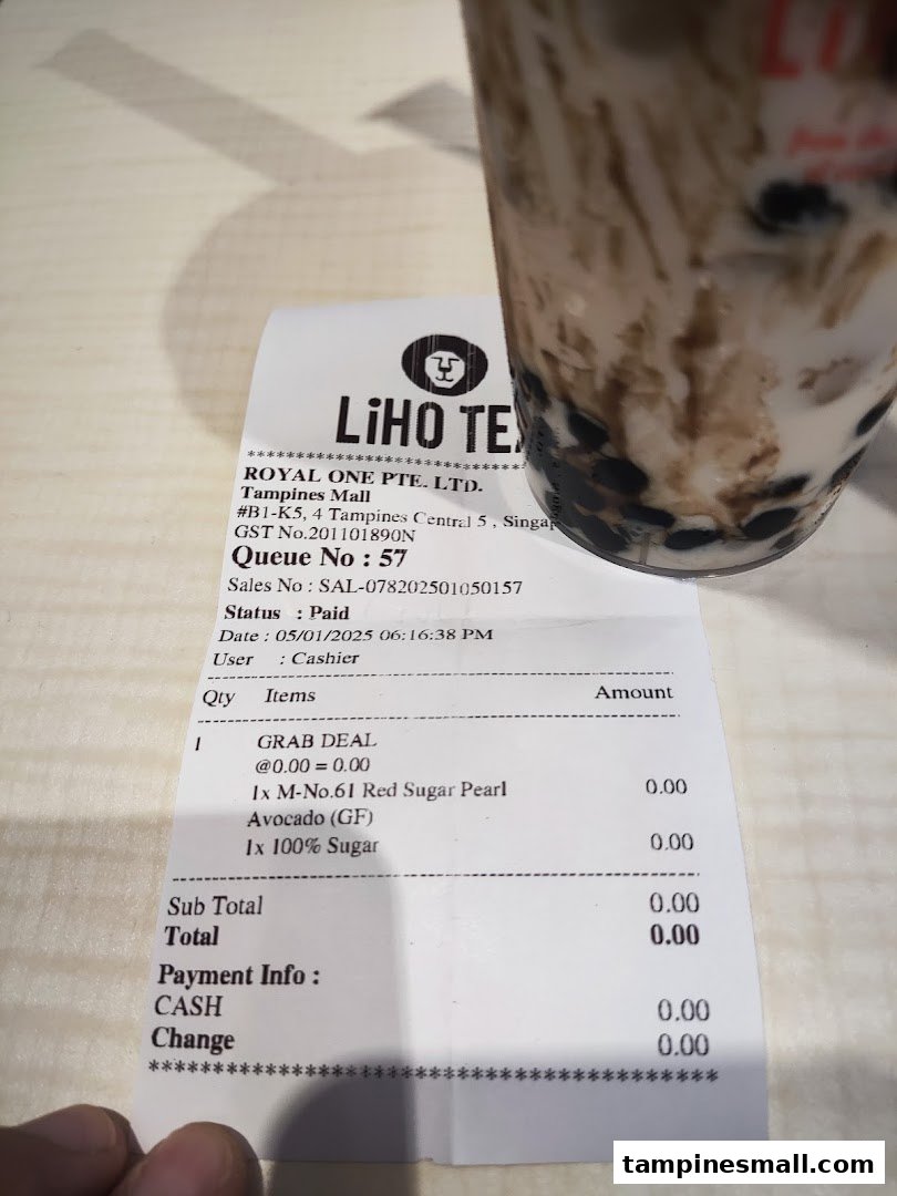 A LiHO TEA receipt and a bubble tea drink on a table.