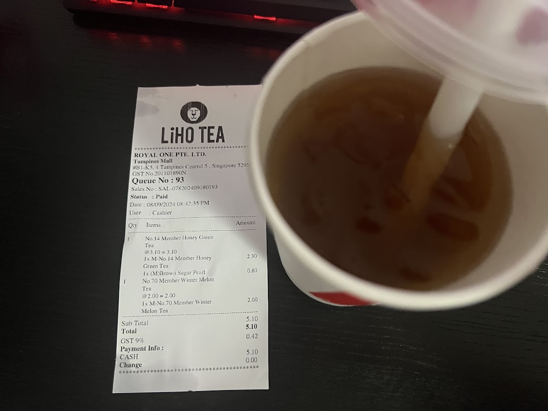 A LiHO TEA receipt displaying purchased items next to a refreshing beverage.
