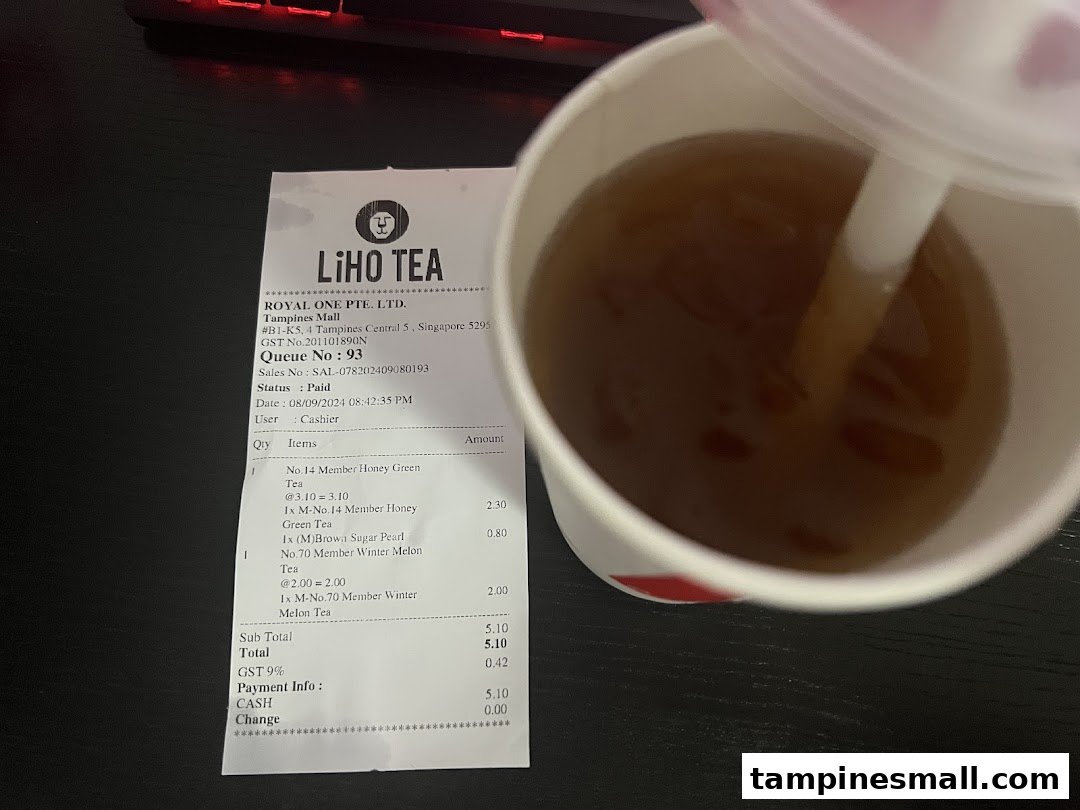 A LiHO TEA receipt displaying purchased items next to a refreshing beverage.