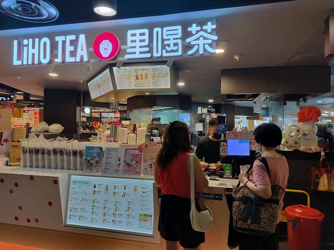 Customers ordering bubble tea at the LiHO TEA counter with prominent menu displays.