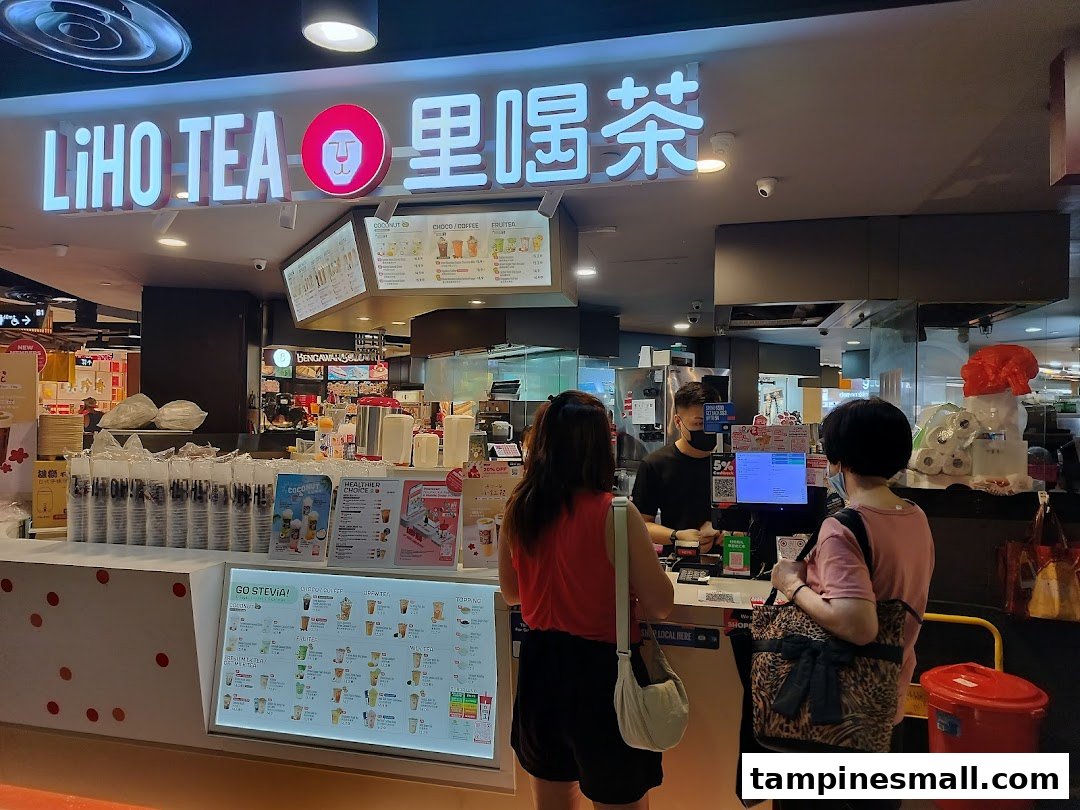 Customers ordering bubble tea at the LiHO TEA counter with prominent menu displays.