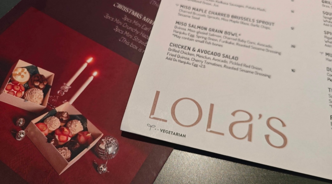A close-up of Lola's menu featuring main dishes and festive Christmas miniature desserts.
