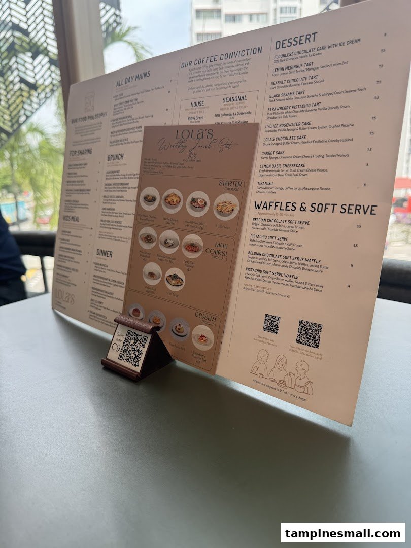 A detailed menu from Lola's cafe, showcasing coffee, desserts, waffles, and a weekday lunch set.