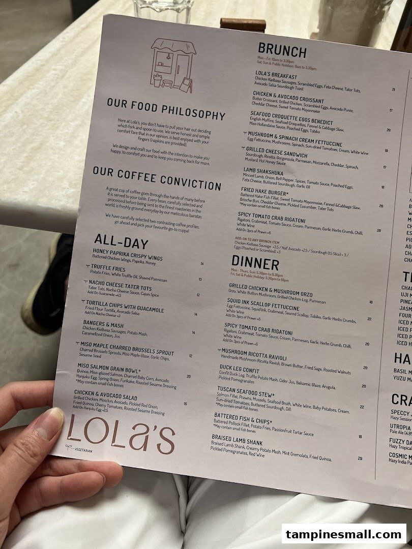 A close-up view of Lola's restaurant menu, featuring food philosophy, coffee conviction, and various dishes.