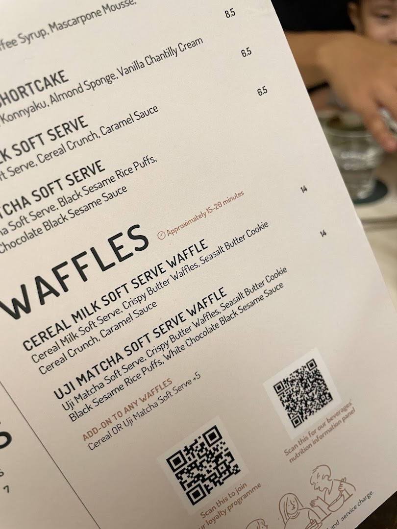 A close-up view of Lola's dessert and waffle menu, showing various sweet treats and prices.