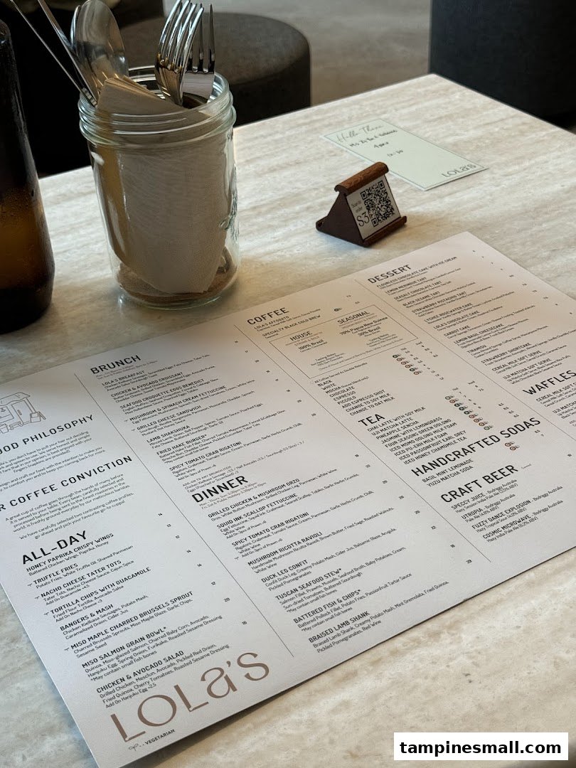 A detailed menu from Lola's cafe, featuring a variety of food and drink options, displayed on a table.