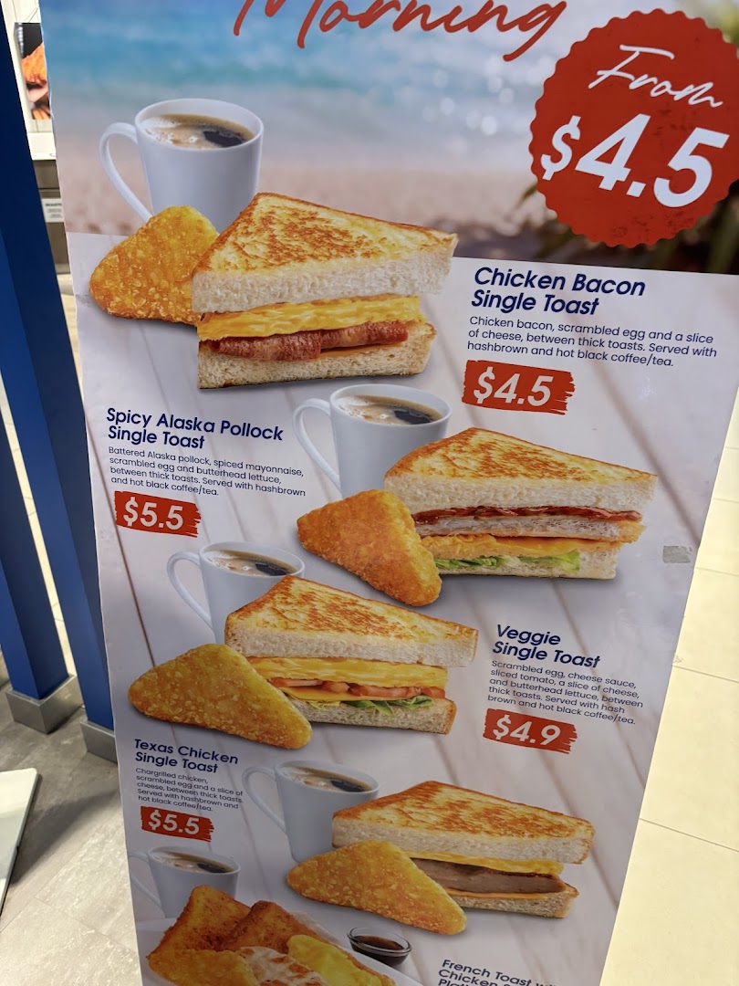 A vibrant menu board showcasing various breakfast toast sets with hashbrowns and coffee/tea.