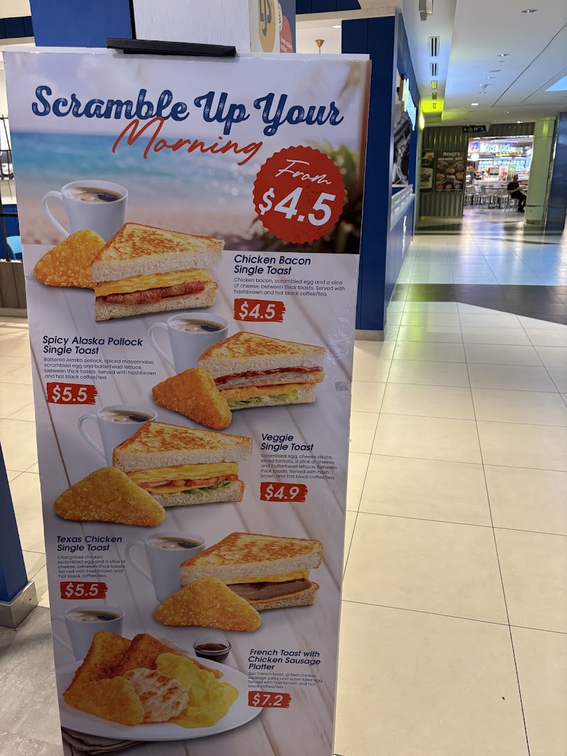 A vibrant breakfast menu stand showcasing various toast and platter options with prices.