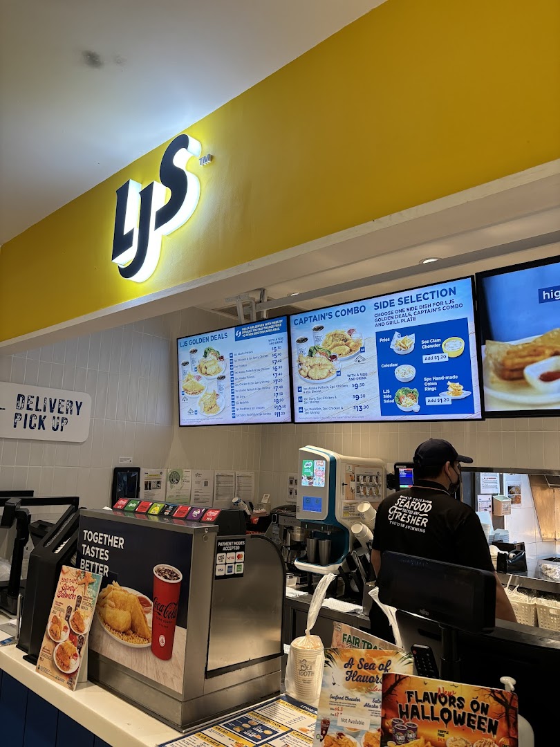 Interior view of Long John Silver's counter with prominent menu boards displaying food items and prices.