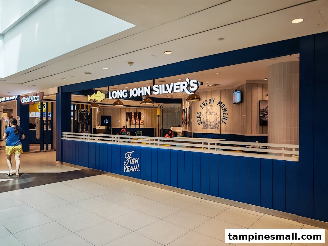 The vibrant blue and white facade of Long John Silver's restaurant within a bustling shopping mall.