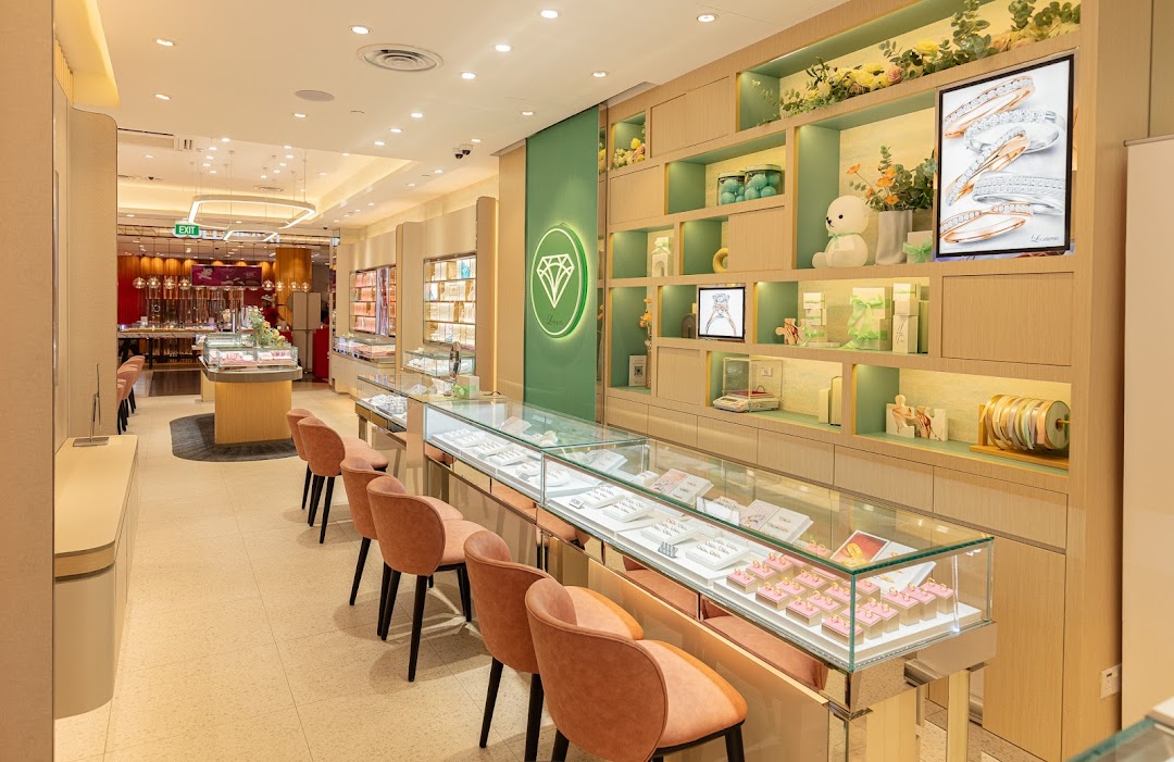 Bright, modern interior of Love & Co. jewelry store with display cases, seating, and elegant decor.