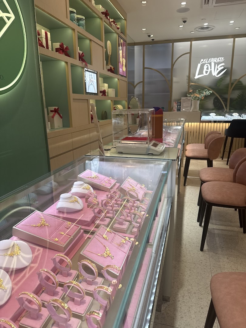 Interior view of Love & Co. jewelry store, showcasing gold jewelry displays and elegant shop decor.