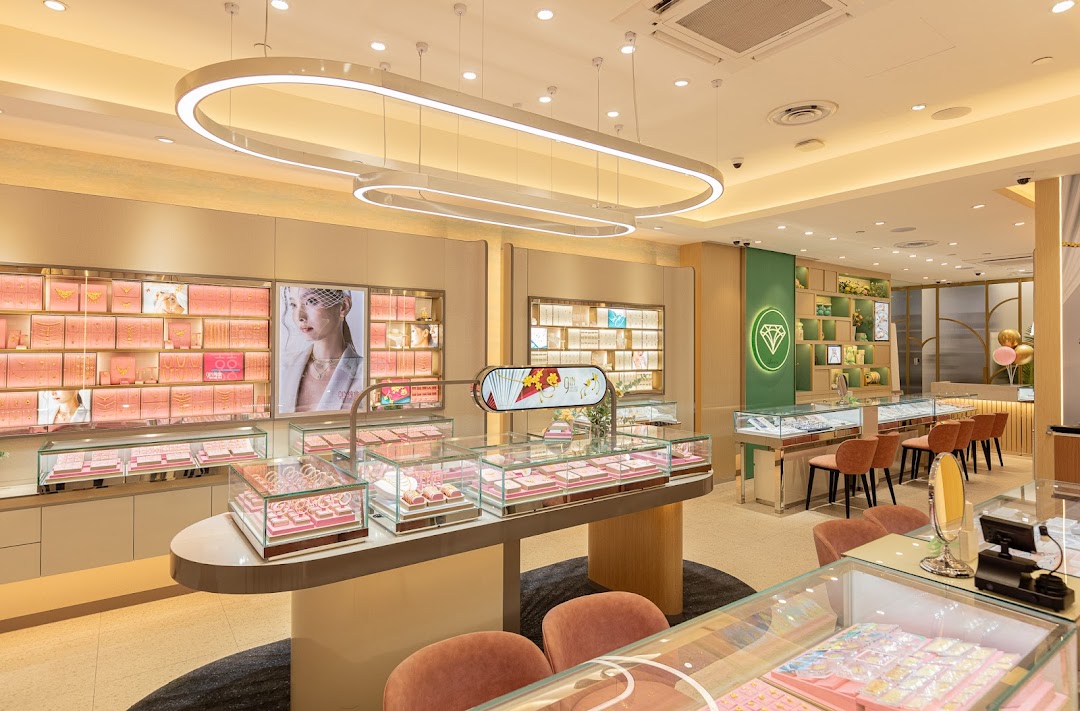 Bright, modern interior of a jewelry store showcasing engagement rings, wedding bands, and other sparkling pieces.