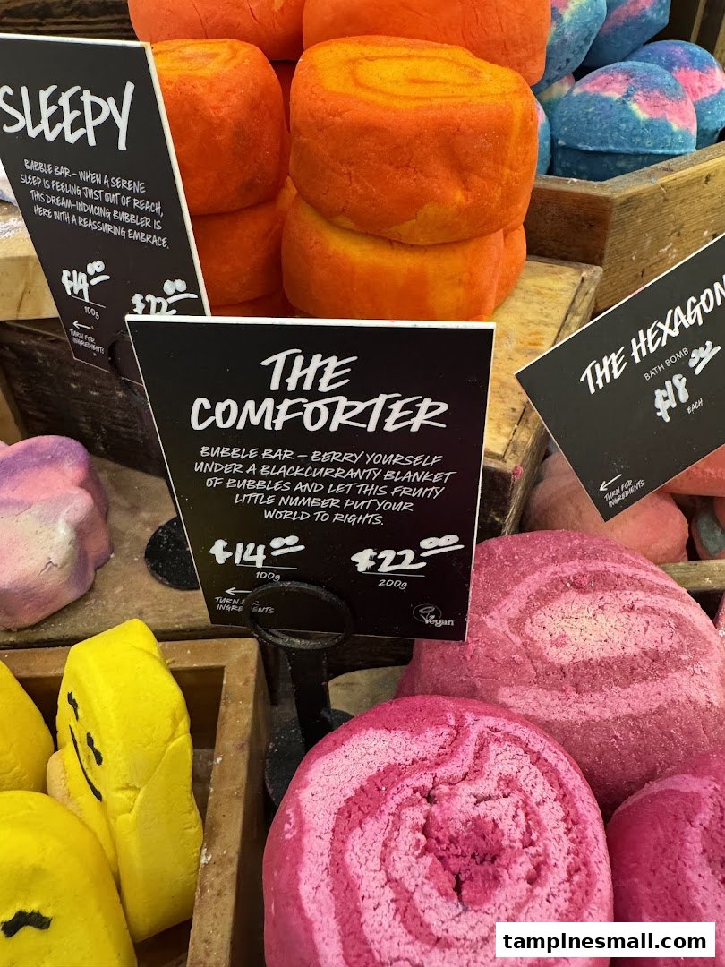 A vibrant display of Lush bubble bars and bath bombs, featuring 'Sleepy', 'The Comforter', and 'The Hexagon' products.