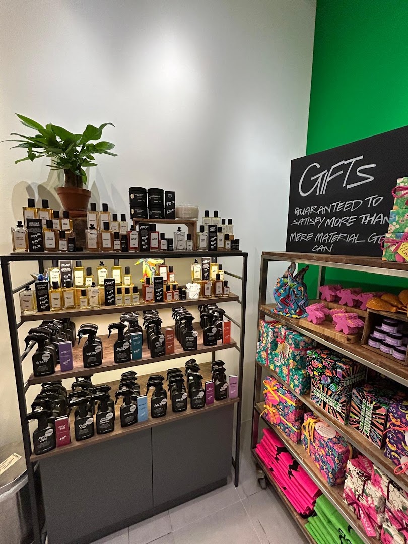 An interior shot of Lush, showcasing a wide array of perfumes, body sprays, and colorful gift sets.