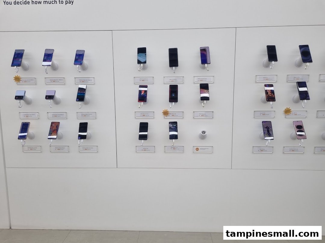 A clean display wall showcasing a wide range of modern smartphones in a retail store.