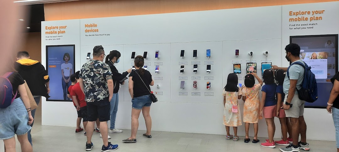 Customers browse mobile devices and explore plans at a modern phone shop.