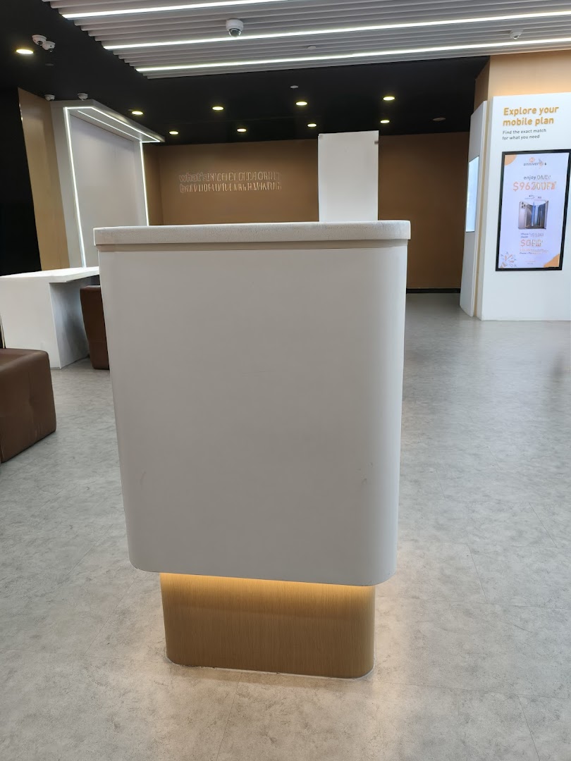 A modern M1 shop interior featuring a central counter and a digital display for mobile plans.