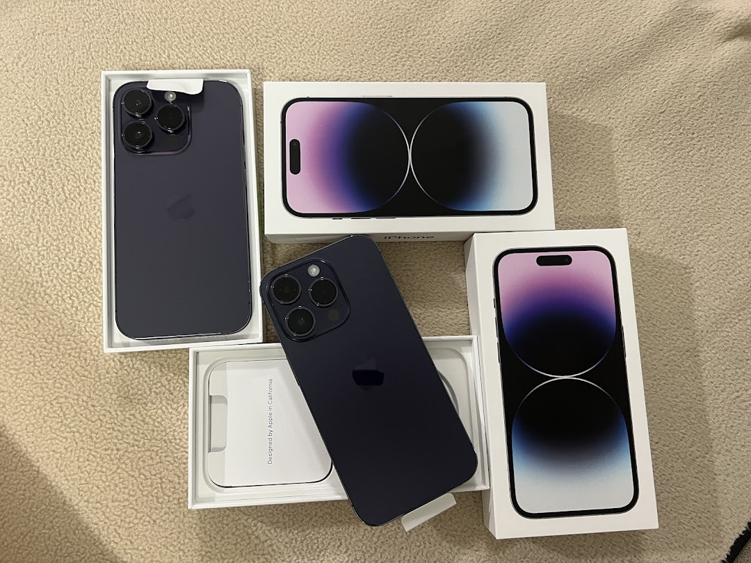 Several new iPhones in their packaging, showcasing the latest models and their boxes.