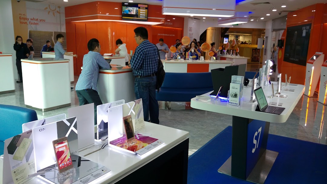 Interior of a vibrant phone and internet service provider shop with customers and product displays.