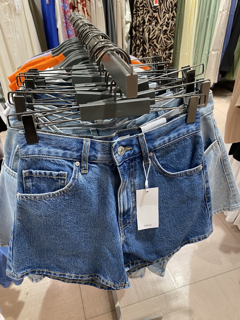 Close-up of denim shorts on display at Mango, showcasing casual wear.