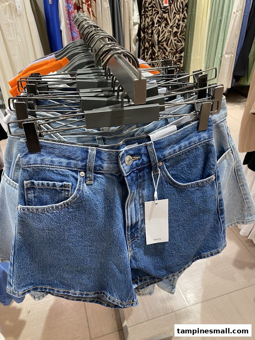 Close-up of denim shorts on display at Mango, showcasing casual wear.