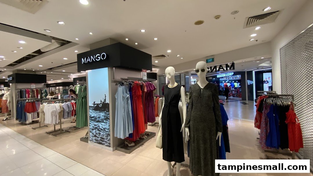 Interior view of MANGO fashion store showcasing diverse clothing collections and mannequins.