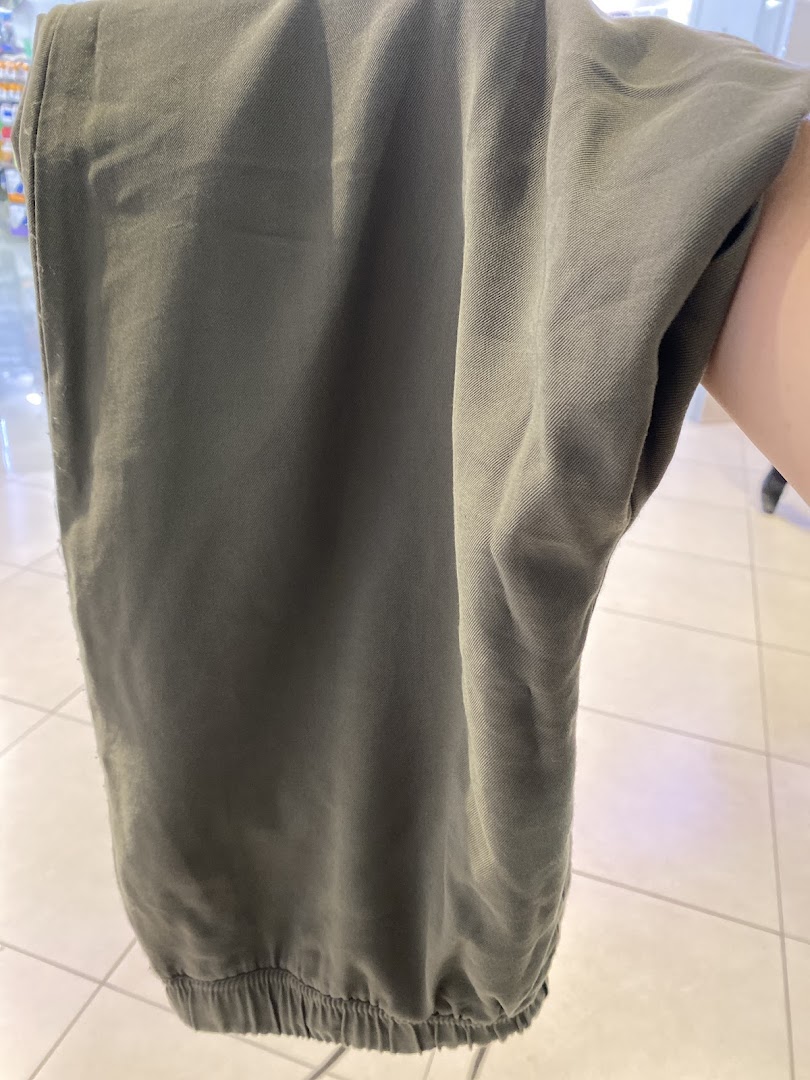 Close-up of olive green pants, showcasing casual fashion from Mango.