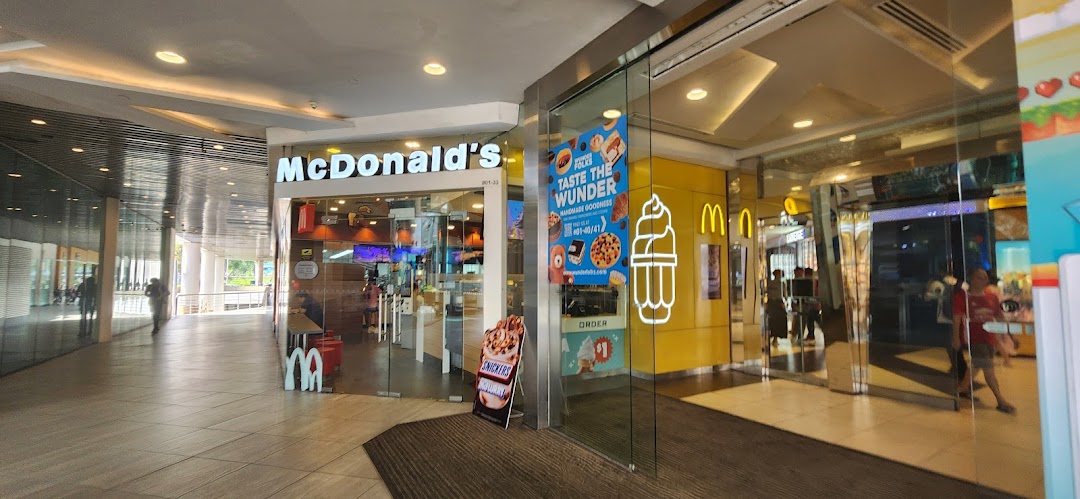 The storefront of McDonald's at Tampines Mall, featuring its entrance and promotional displays.